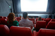 © Syda Productions - happy couple watching movie in theater or cinema