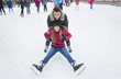 Ice skating couple having winter fun on ice skates Quebec, Canada.