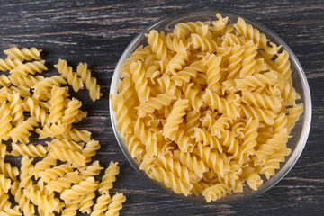 Wall Mural - raw Italian pasta on a dark wooden background