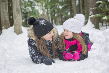 Two girls looking at camera in winter park