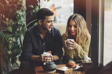 Wall Mural - Couple in love drinking coffee in coffee shop