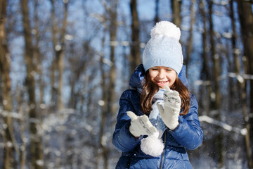 Little girl outdoors on beautiful winter snow day