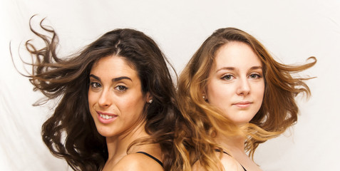 Portrait of two beautiful women who were moving her hair