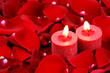 red candles and rose petals background