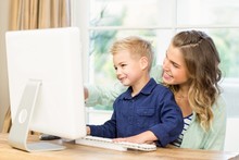 Mother And Son Using The Computer