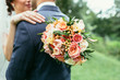 Bride holding wedding bouquet and hug groom on wedding ceremony