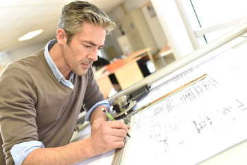 Wall Mural - Architect working on drawing table in office