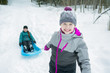 © Louis-Paul Photo - Children Pulling Sledge Through Snowy Landscape