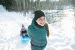 © Louis-Paul Photo - Children Pulling Sledge Through Snowy Landscape