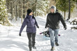 © Louis-Paul Photo - Family Pulling Sledge Through Snowy Landscape