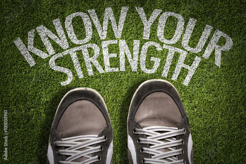 Fotografía Top View of Sneakers on the grass with the text: Know Your Strength