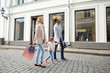 © Syda Productions - happy family with child and shopping bags in city