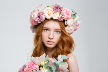 Poster - Tender female in roses wreath holding bouquet of flowers