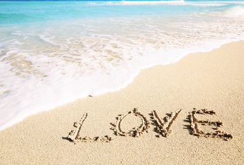 Love inscribed in the sand of a beach