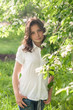 © svetlanafoto - young girl posing in a park in spring blooming garden