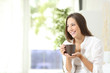 Woman drinking coffee or tea at home