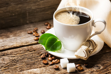 Wall Mural - Close-up of coffee cup with roasted coffee beans on wooden backg