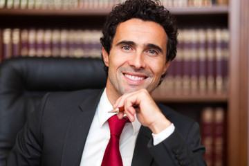 Poster - Portrait of an handsome smiling businessman in his office