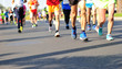 © lzf - Unidentified marathon athletes legs running on city road