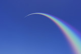 Fototapeta Tęcza - Rainbow Arcing Through Blue Sky