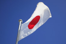 Closeup Of A Japanese Flag With Blue Sky
