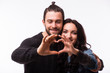 © F8  \ Suport Ukraine - Valentine couple. Portrait of smiling beauty girl and her handsome boyfriend making shape of heart by their hands. Happy joyful family. Love concept. Heart sign. Laughing happy lovers. Valentines Day