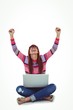 © WavebreakmediaMicro - Smiling hipster woman using laptop while putting hands up
