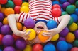 © WavebreakmediaMicro - Cute smiling boy in sponge ball pool