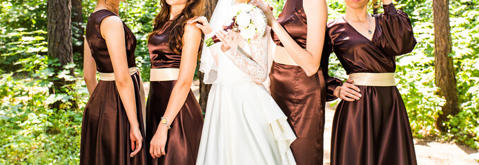 Bride and bridesmaids near trees