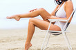 © Syda Productions - close up of woman sunbathing in lounge on beach