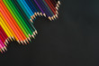 Colour pencils on black background.