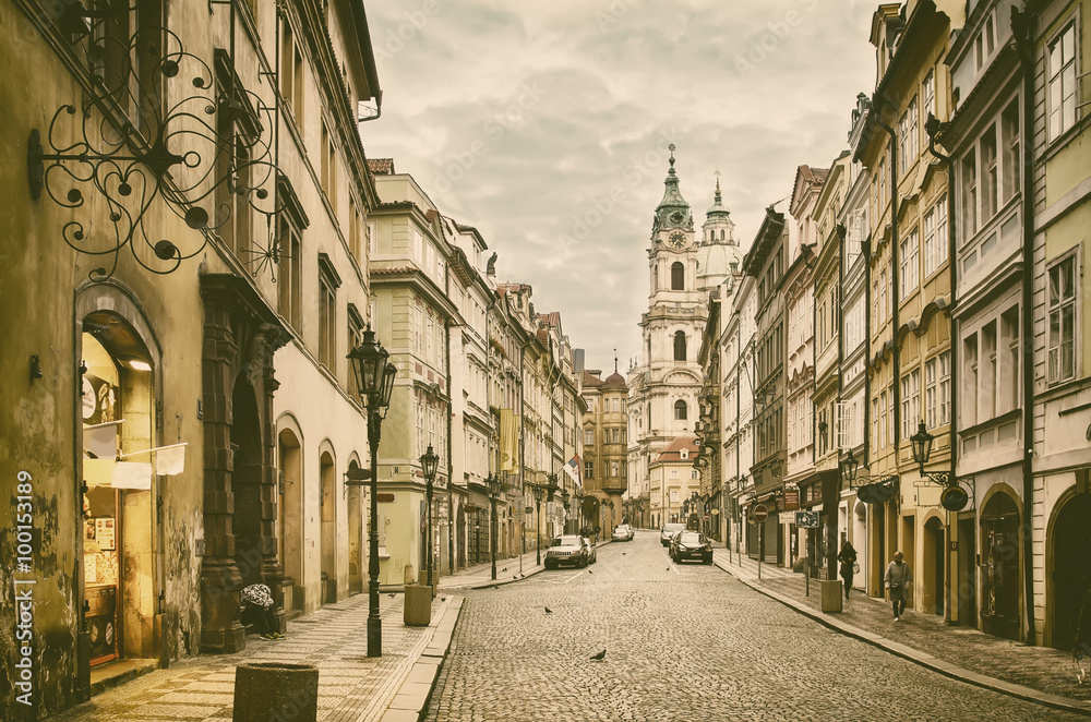 View to the street in the old center of Prague - the capital and largest city of the Czech Republic - vintage sepia retro travel background - obrazy, fototapety, plakaty 