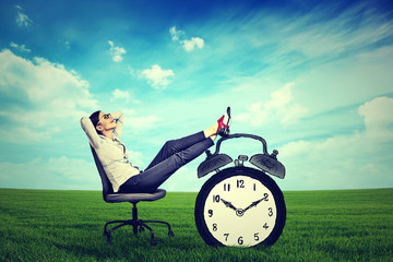 young business woman corporate executive relaxing sitting on a chair in the open air outdoors