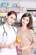 © DC Studio - Pharmacy worker showing product to client