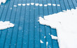 blue metal sheet roof covered with snow in winter season.