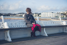 Young Woman Relaxing On The Pier