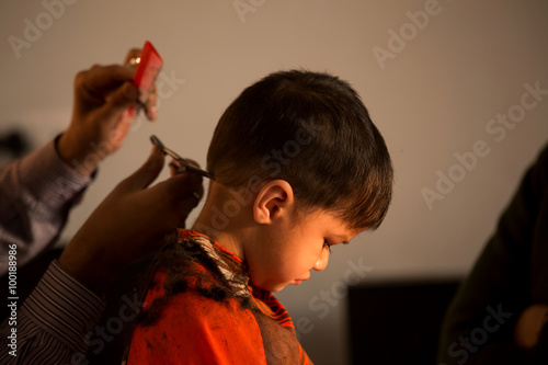 Two Year Old Kid Having A Haircut With Wet Eyes After Crying Early