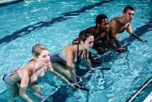 Fit Smiling Group Pedaling On Swimming Bike