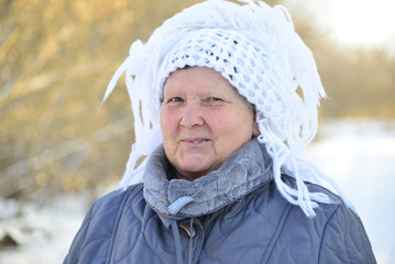 Wall Mural - elderly woman in  white knitted shawl on her head 