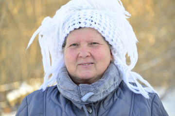 Wall Mural - elderly woman in  white knitted shawl on her head 