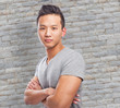 © asierromero - Handsome young asian man crossing his arms and smiling
