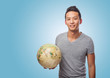 © asierromero - young asian man holding a world globe