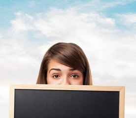 Wall Mural - portrait of student hidden behind a chalkboard