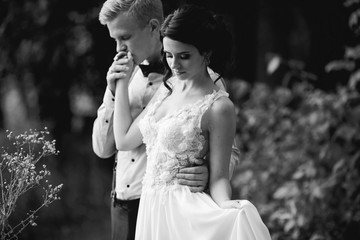 groom gently embracing his bride