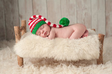 Newborn Baby Boy Wearing A Christmas Elf Hat