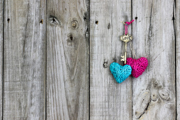 Wall Mural - Key and hearts hanging on rustic wood door