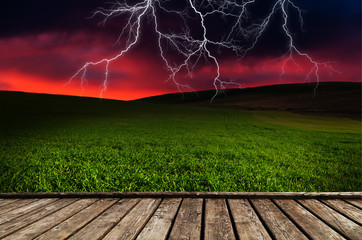 Wall Mural - thunderstorm with lightning in green meadow