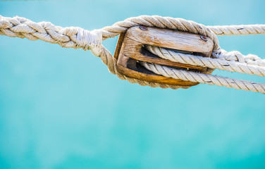 Nautical old wooden pulley with ropes