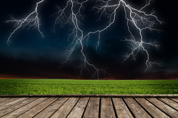 Wall Mural - thunderstorm with lightning in green meadow