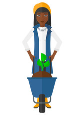 Poster - Woman with plant and wheelbarrow.